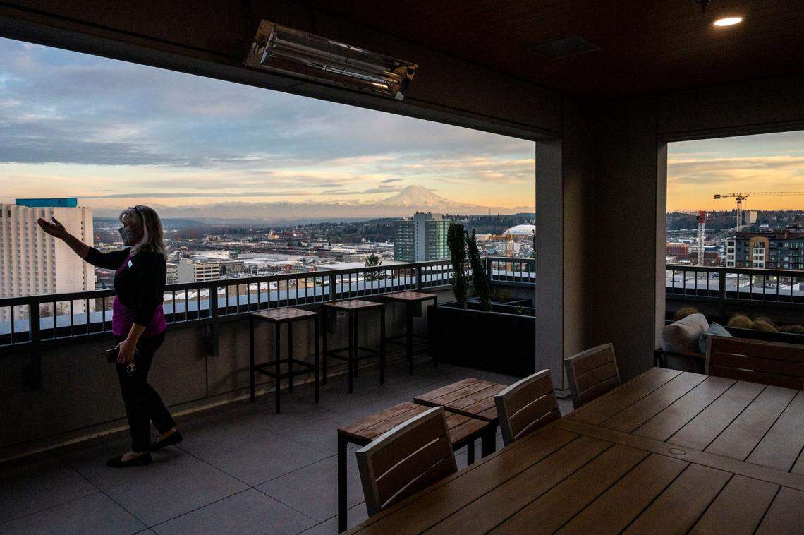 A Hailey employee shows how the rooftop terrace on the northeast side of the building offers an amazing view of everything between Commencement Bay and Mount Rainier, as seen on Feb. 9, 2022, in downtown Tacoma.