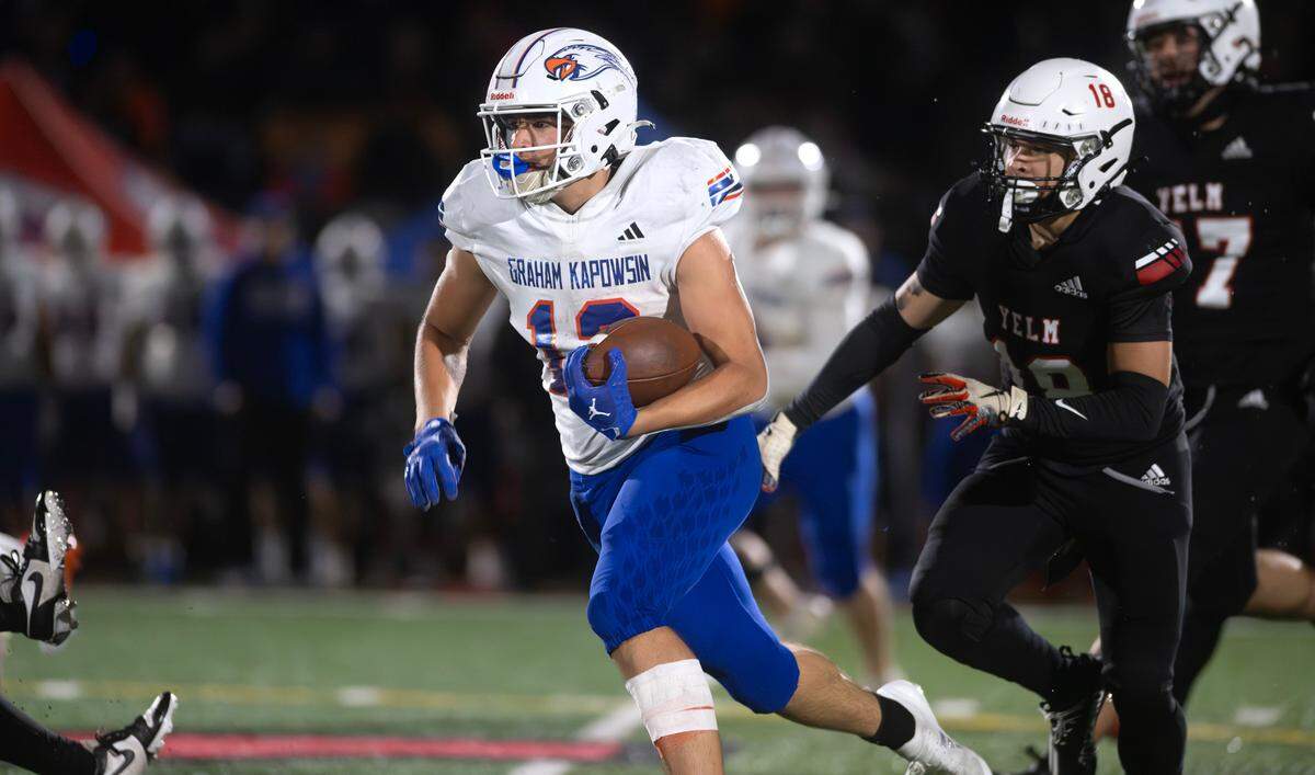 Graham Kapowsin running back Blake Pearson breaks loose in front of Yelm defensive back Tonye Penn during Friday night’s football game at Yelm High School in Yelm, Washington, on Oct. 4, 2024.