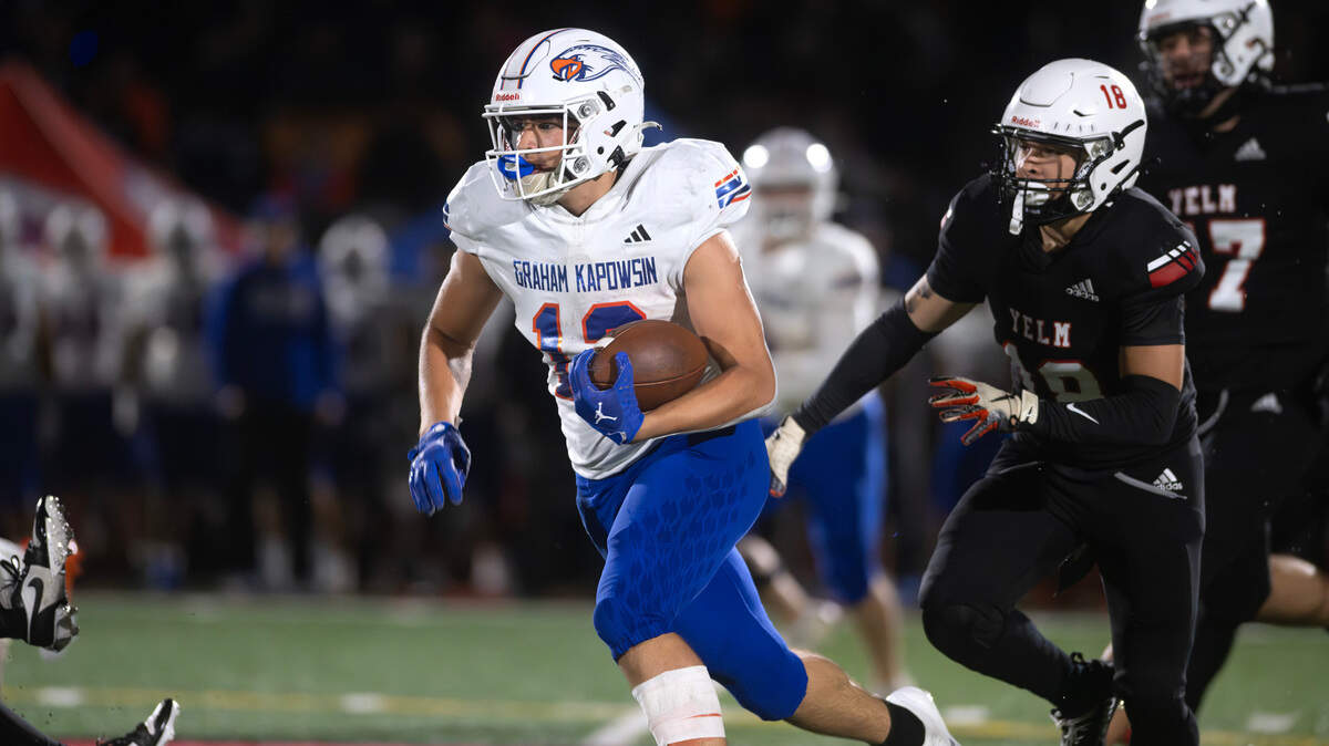 Graham Kapowsin running back Blake Pearson breaks loose in front of Yelm defensive back Tonye Penn during Friday night’s football game at Yelm High School in Yelm, Washington, on Oct. 4, 2024.