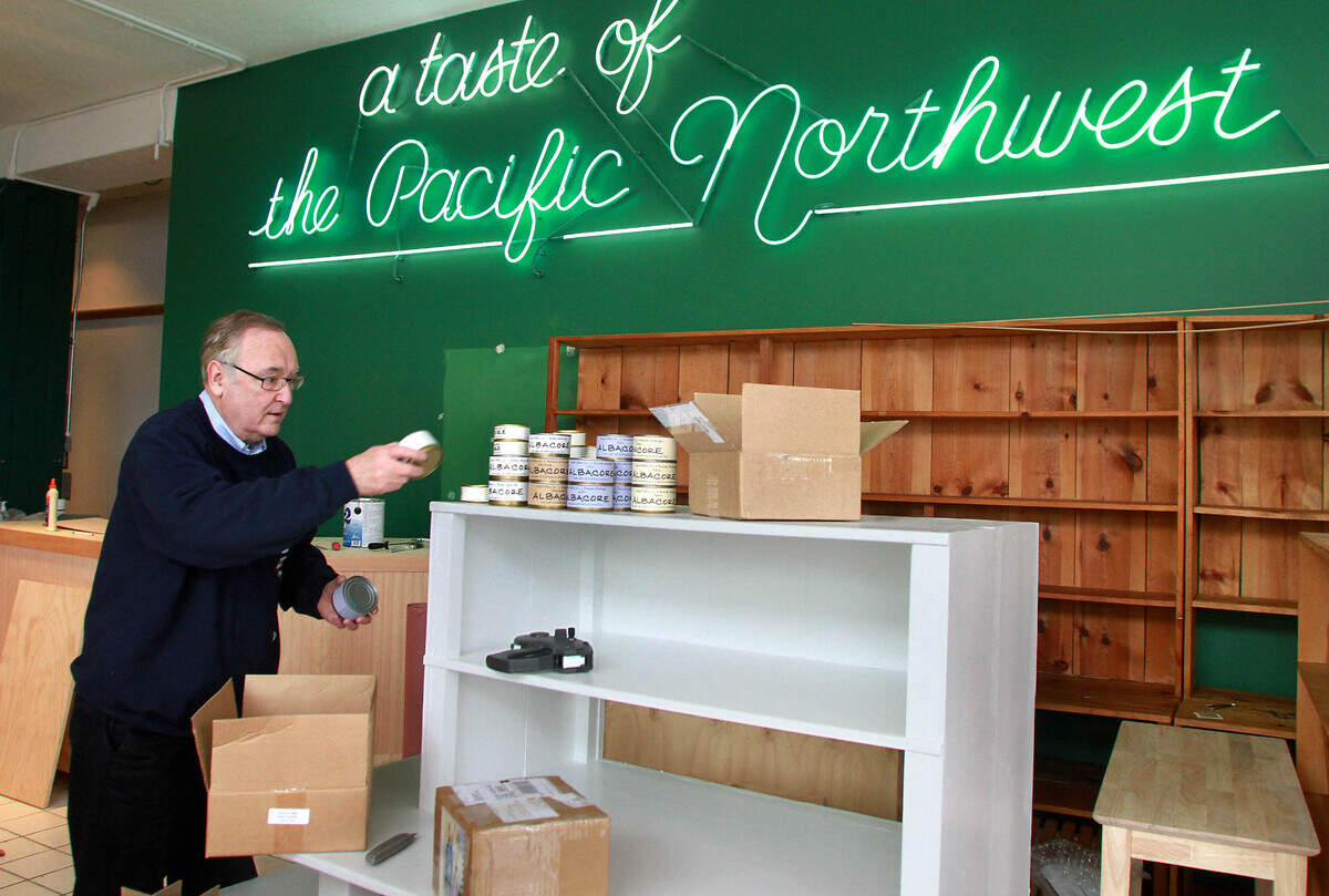 Bill Evans stocks shelves on March 26, 2010, in Proctor, as he prepares to reopen his Pacific Northwest Shop.