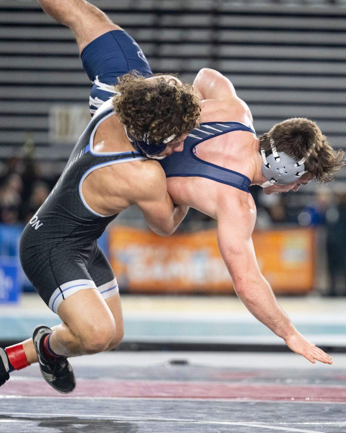 Rogers’ Josiah Taijeron throws Glacier Peak’s Colin Edmonds to the mat during their Class 4A, 165-pound championship match on Friday, Feb. 21, 2025, at Mat Classic XXXVI at the Tacoma Dome in Tacoma, Wash.