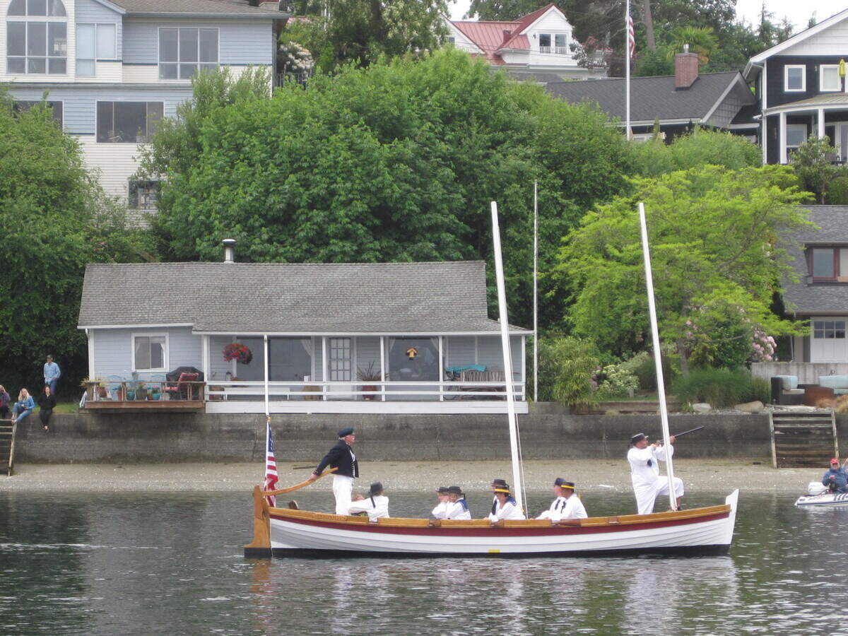 The survey gig replica, The Porpoise, enters the harbor during a 2016 historical reenactment ceremony.