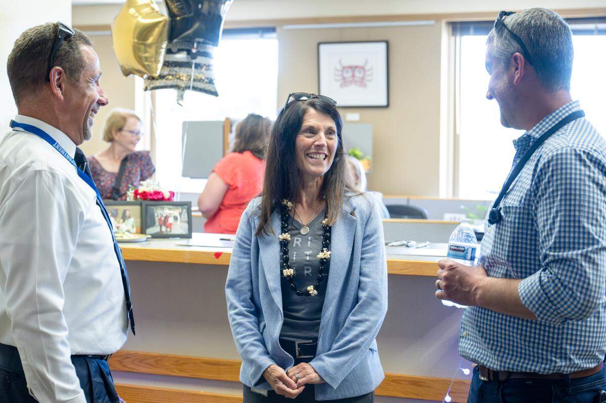 Retiring Tacoma City Manager Elizabeth Pauli, center, speaks with city staff and friends gathered for a retirement reception for Pauli on Tuesday, July 1, 2025, in Tacoma.