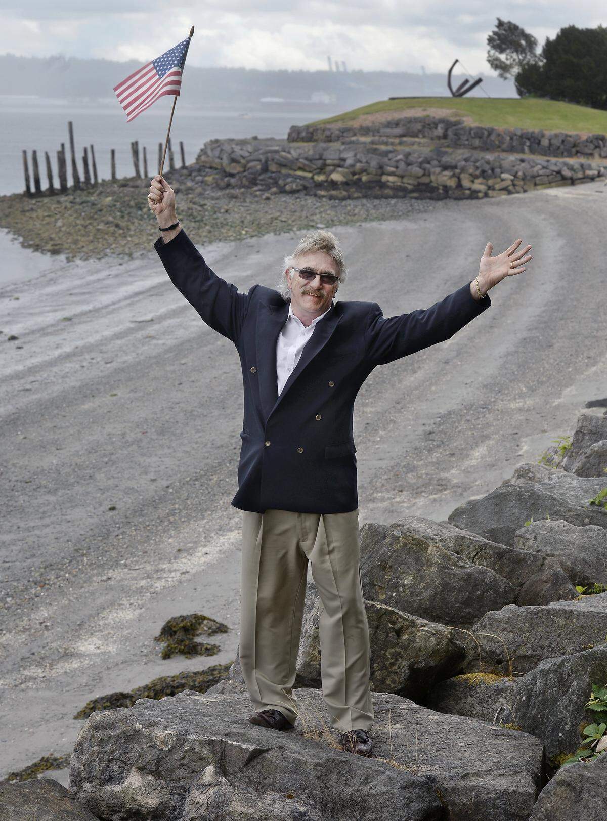 Gary Grape, the director of Freedom Fair, flies the annual Fourth of July event’s favorite colors Friday, June 27, 2014. Behind him is Jack Hyde Park, one of the prime viewing areas for the fireworks show along Tacoma’s Ruston Way.