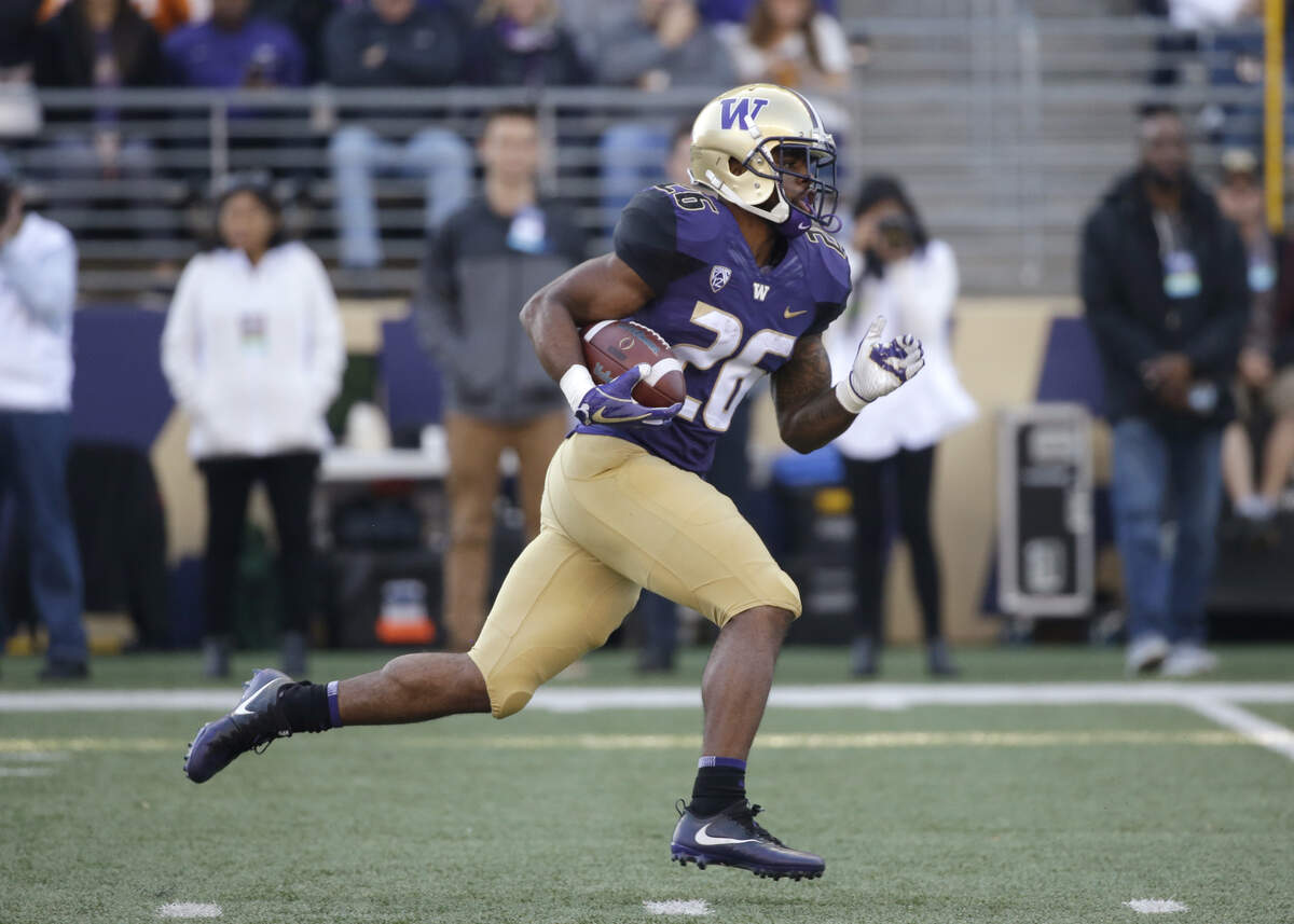 Washington’s Salvon Ahmed returns a punt 82 yards against Washington in the first half of an NCAA college football game Saturday, Oct. 28, 2017, in Seattle. (AP Photo/Elaine Thompson)