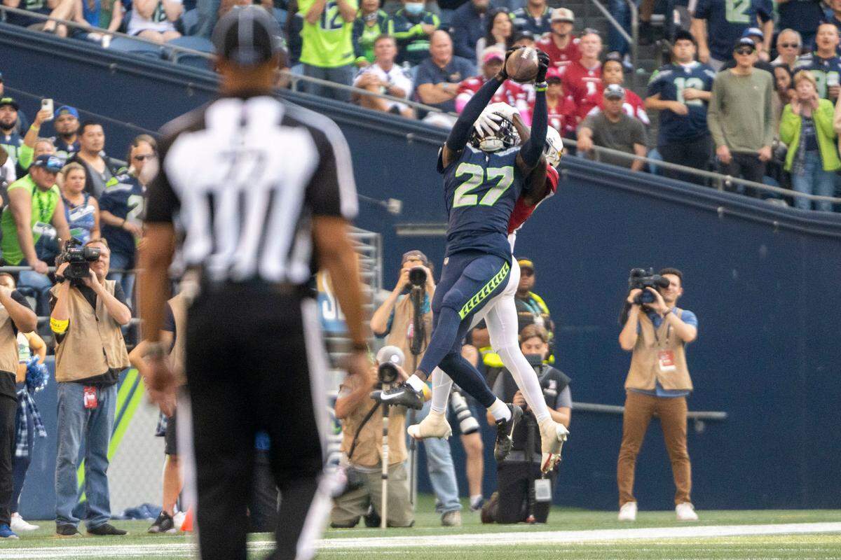Seattle Seahawks cornerback Tariq Woolen (27) intercepts a pass by Arizona Cardinals quarterback Kyler Murray (1) intended for wide receiver Marquise Brown (2) during the fourth quarter of an NFL game on Sunday, Oct. 16, 2022, at Lumen Field in Seattle.