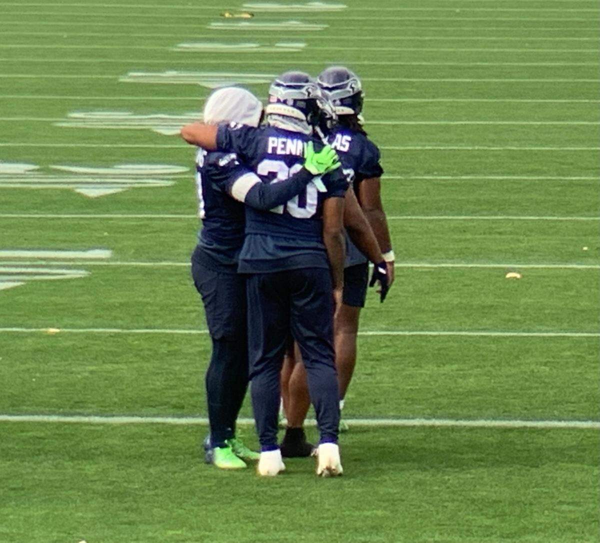 Rashaad Penny (20) hugs fellow running back Alex Collins (left) upon Penny’s return from the injured-reserve list to Seahawks practice Thursday at team headquarters in Renton. Collins did not practice for Seattle’s game Monday against New Orleans. Collins started last weekend in Pittsburgh for lead back Chris Carson, who remains on injured reserve.