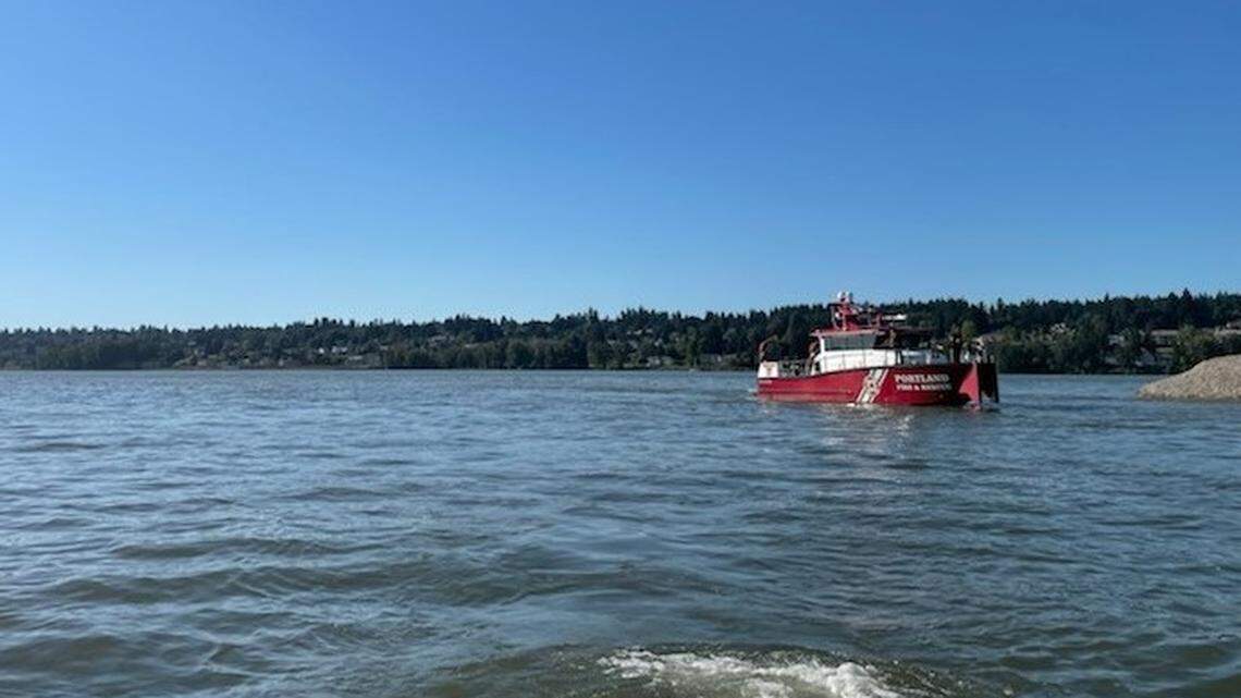 A Portland Fire & Rescue boat searches the Columbia River for a man who went missing after jumping from a boat to try to help a woman struggling to swim.
