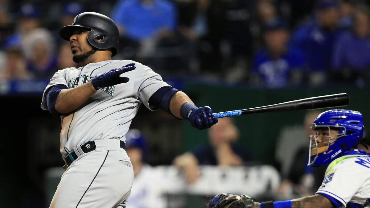 Seattle Mariners first baseman Edwin Encarnacion hits a three-run home run off Kansas City Royals relief pitcher Kevin McCarthy during the sixth inning of a baseball game at Kauffman Stadium in Kansas City, Mo., Monday, April 8, 2019. It was the second home run of the inning for Encarnacion. (AP Photo/Orlin Wagner)