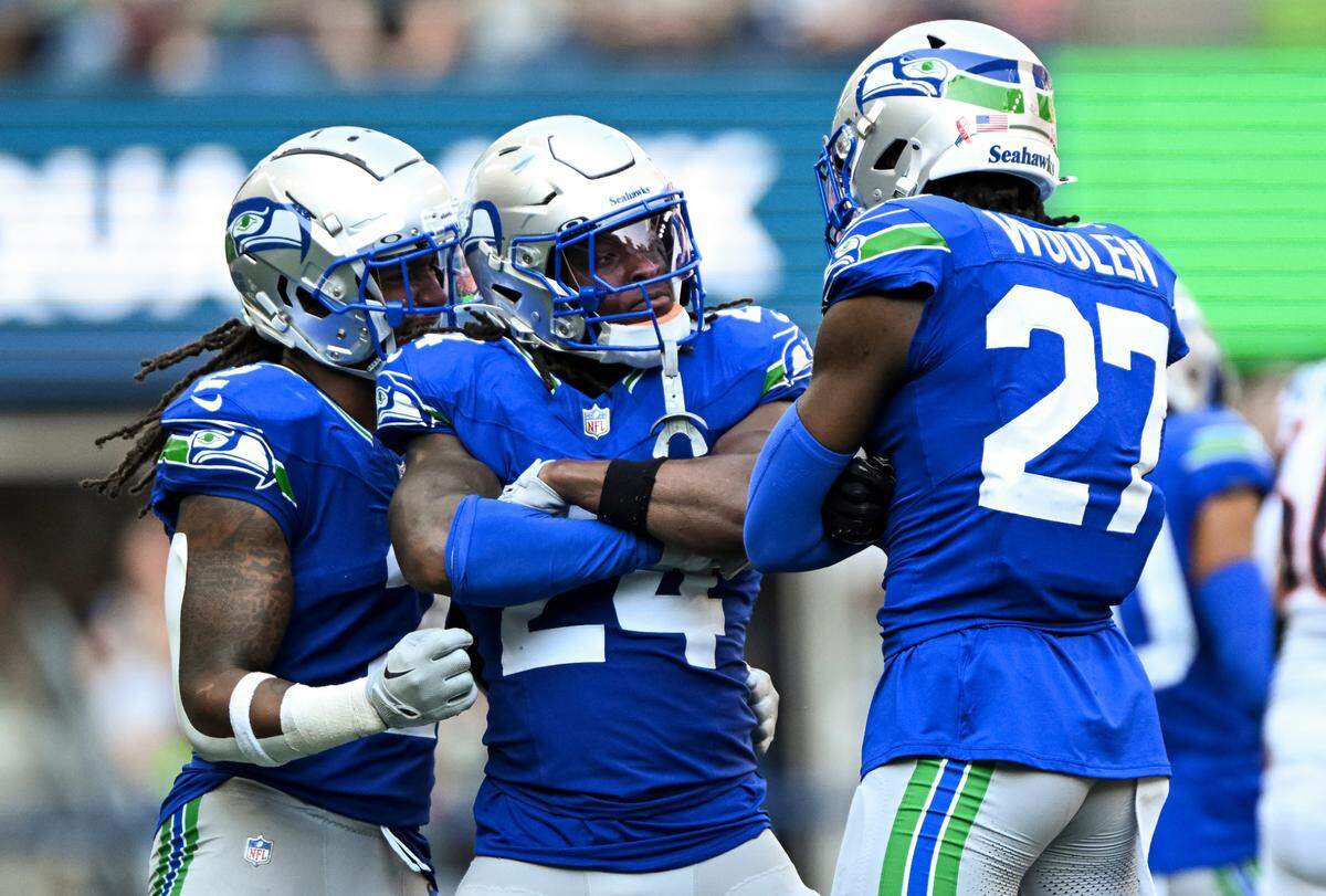 Seattle Seahawks safety K’Von Wallace (24) and cornerback Riq Woolen (27) react to a defensive stop against the Denver Broncos during the third quarter of the game at Lumen Field, on Sunday, Sept. 8, 2024, in Seattle, Wash.