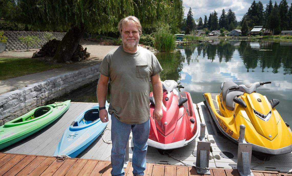 Ed Larson has been working for years to protect the waters alongside his home on Spanaway Lake, Washington, shown on Tuesday, Aug. 10, 2023. He is concerned that a proposed tiny-home village surrounded by wetlands that feed into the lake will exacerbate pollution problems.