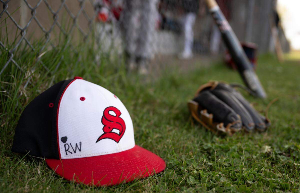 A “RW” to remember Reese Widman, who passed last winter from suicide, is seen on his teammate and friend Josiah Morley’s hat during a practice at Steilacoom High School, on Monday, April 15, 2024, in Steilacoom, Wash. 