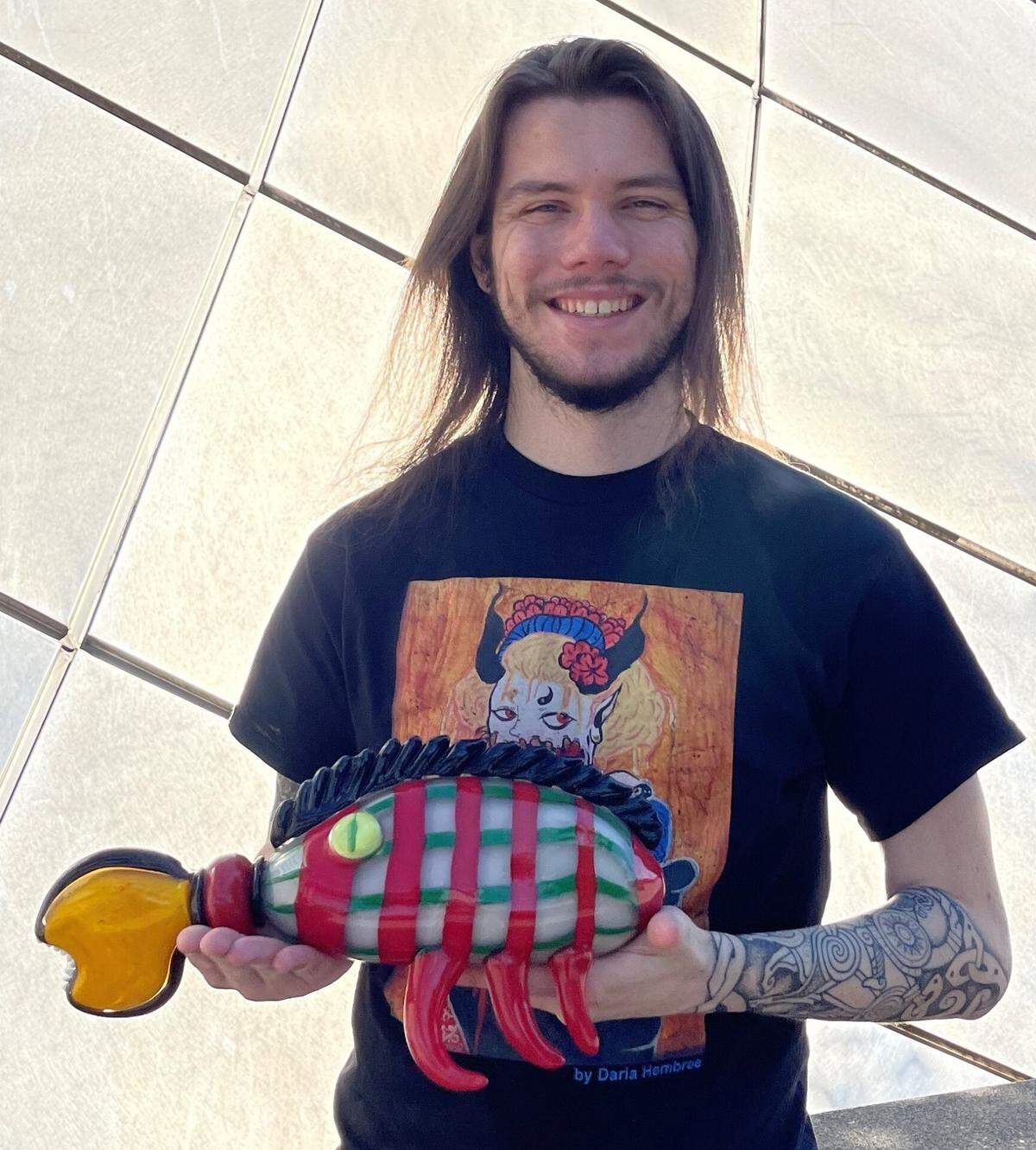 Mason Winchell in 2024 with his 2010 creation, “Lioncrab,” outside the Museum of Glass.