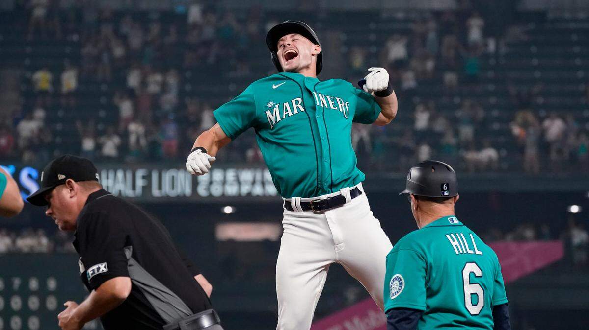 Seattle Mariners’ Jarred Kelenic reacts to drawing a bases-loaded walk to drive in the winning run in the ninth inning of the team’s baseball game against the Toronto Blue Jays on Friday, Aug. 13, 2021, in Seattle. The Mariners won 3-2. (AP Photo/Elaine Thompson)