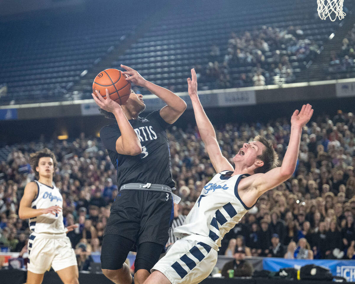 Curtis guard Devin Whitten (3) collides with Olympia guard Matt Lindblom (4) as he attempts a layup during the third quarter of the Class 4A championship game on Saturday, March 4, 2023, in Tacoma, Wash. Lindblom was called for a foul on the play.