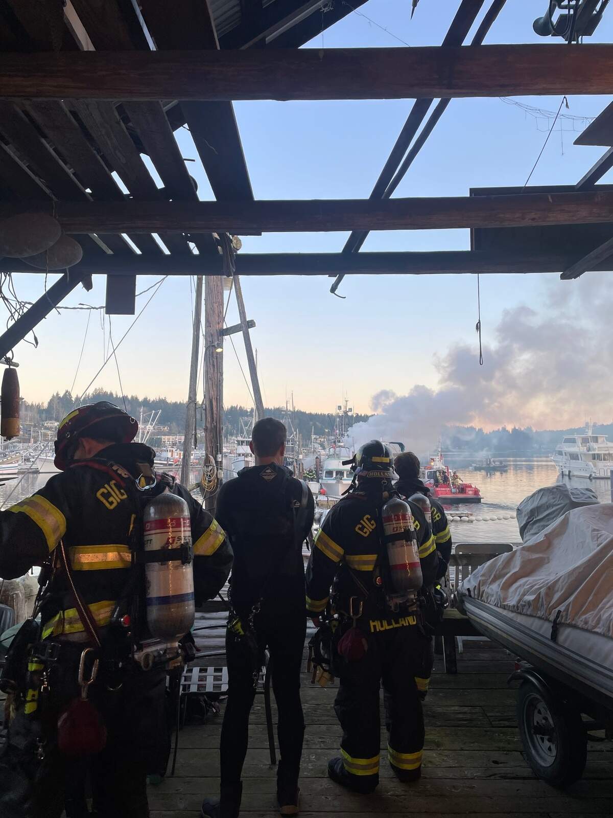 Gig Harbor Fire & Medic One firefighters respond to a fire on Bujacich Dock in Gig Harbor, Wash., with assistance from a West Pierce Fire & Rescue fire boat on Saturday, Jan. 25, 2025.