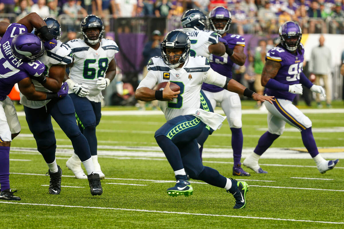 Seattle Seahawks quarterback Russell Wilson (3) runs against the Minnesota Vikings in the first half of an NFL football game in Minneapolis, Sunday, Sept. 26, 2021. (AP Photo/Bruce Kluckhohn)
