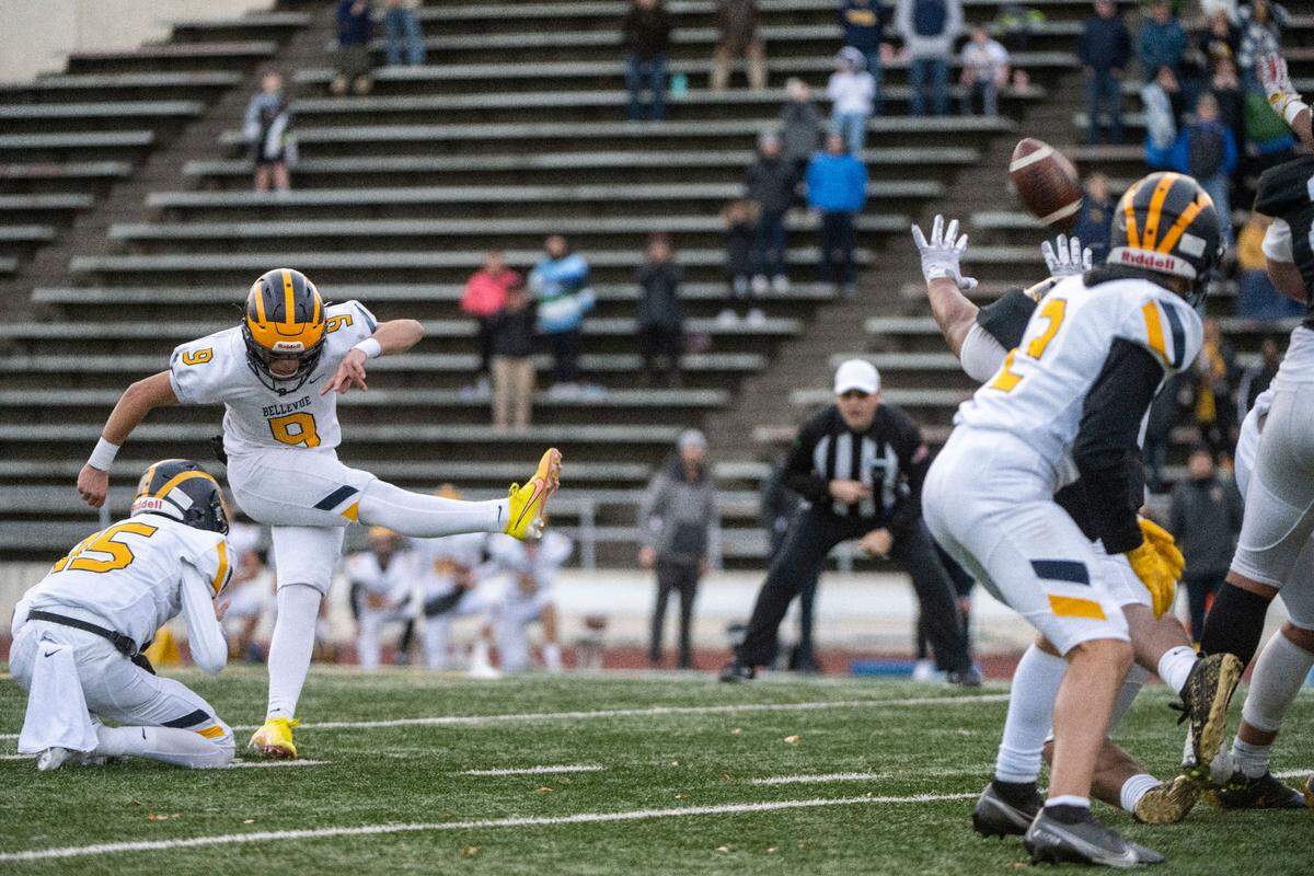 Bellevue’s Luke Scoma attempts a 43-yard field goal with 16.5 seconds to play in the fourth quarter of a Class 3A state quarterfinal game against Lincoln on Saturday, Nov. 19, 2022, at the Lincoln Bowl in Tacoma, Wash. Scoma’s field goal squeaked over the cross bar then bounced back onto the field on play. The ricochet caused confusion for both teams. Lincoln players ran toward their sideline exuberant that they had held on for the win, while the referees underneath the goal posts were calling the kick good. Scoma’s field goal won the game for the Wolverines, 22-20.