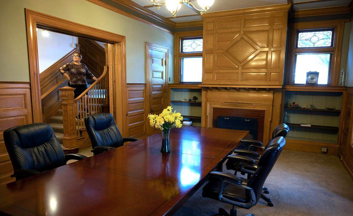 Property manager Paula Squillacote looks over the conference room at the Blackwell Mansion in downtown Tacoma on Tuesday, Sept. 27, 2022.