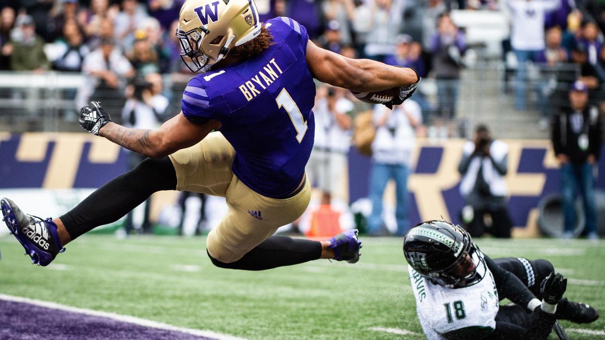 Washington Huskies tight end Hunter Bryant (1) is airborne as he scores a touchdown during the first quarter. The University of Washington played University of Hawai’i in a NCAA football game at Husky Stadium in Seattle, Wash., on Saturday, Sept. 14, 2019.