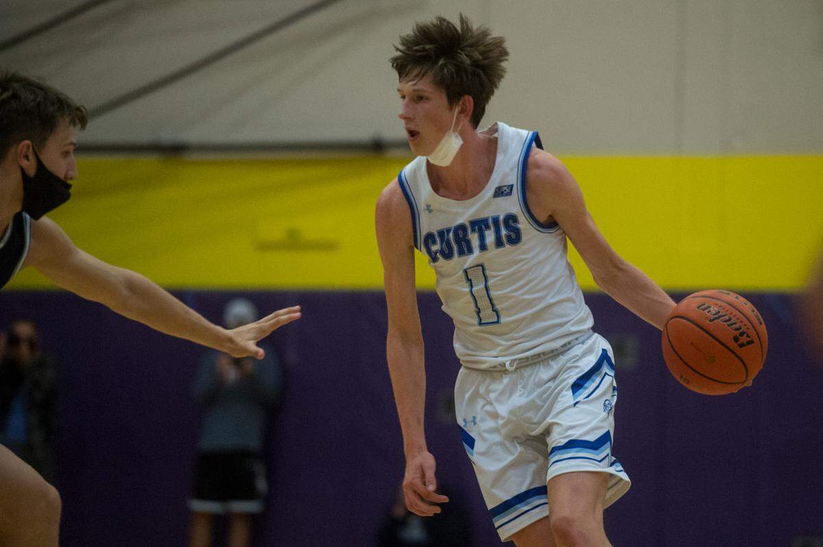 Curtis High School guard Tyce Paulsen brings the ball up court during the 4A SPSL boys basketball championship game against Olympia on Thursday, June 10, 2021 at Puyallup High School in Puyallup, Wash.