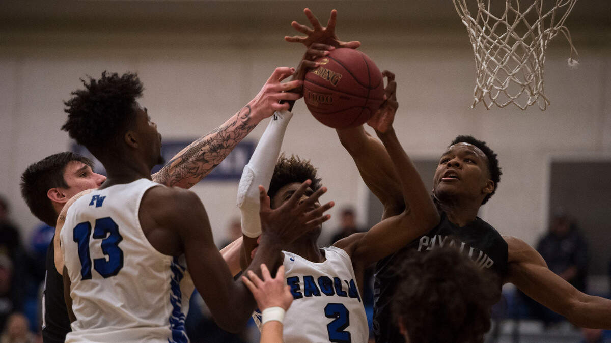 Puyallup High School’s Kendall Munson, right, attempts a block against Federal Way’s Jaden McDaniels (2). Puyallup played Federal Way in a basketball game at Stadium High School in Tacoma, Wash., on Wednesday, Feb. 13, 2019.