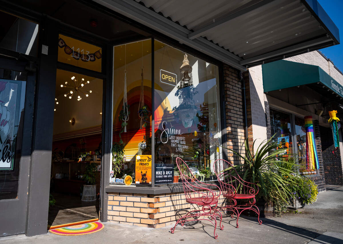 The front window of Sunne Plant Shop, a new local business owned by Desiray O’Brien, is full of various plants and disco balls in downtown Sumner, Wash. on Oct. 13, 2022.