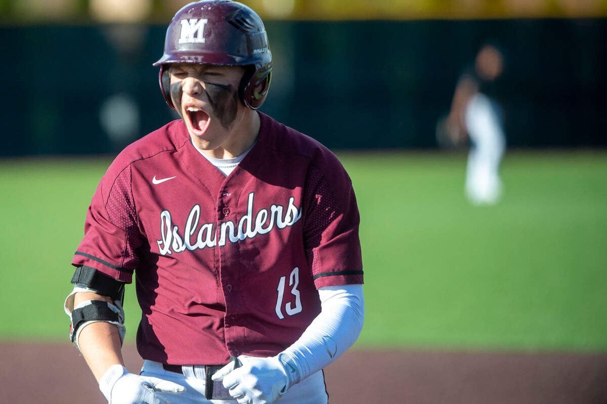Mercer Island’s Jack Varney celebrates after hitting a sacrifice fly to score a run in the bottom of the fourth inning of a State 3A playoff quarterfinal against Auburn on Saturday, May 21, 2022, at Auburn High School in Auburn, Wash.