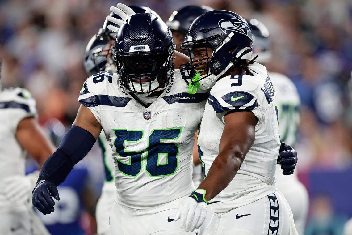 Seattle Seahawks running back Kenneth Walker III (9) celebrates with linebacker Jordyn Brooks (56) after scoring a touchdown against the New York Giants during the second quarter of an NFL football game, Monday, Oct. 2, 2023, in East Rutherford, N.J. (AP Photo/Adam Hunger)
