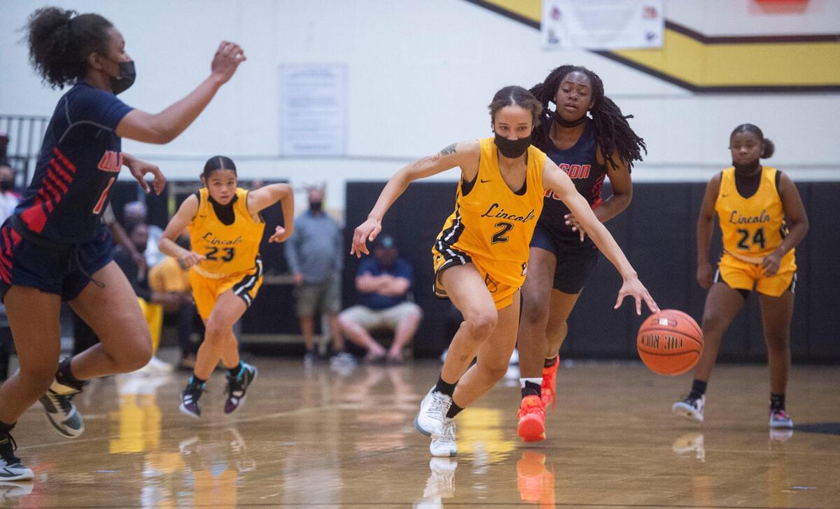 Lincoln’s Kristol Ayson leads a fast break as the Lady Abes rout the Wilson Rams, 85-46, in a crosstown rivalry game on their home court in Tacoma on Friday, May 21, 2021.