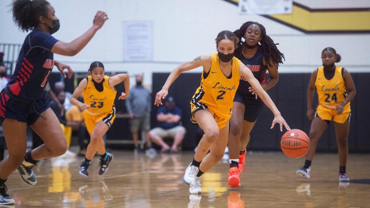Lincoln’s Kristol Ayson leads a fast break as the Lady Abes rout the Wilson Rams, 85-46, in a crosstown rivalry game on their home court in Tacoma on Friday, May 21, 2021.