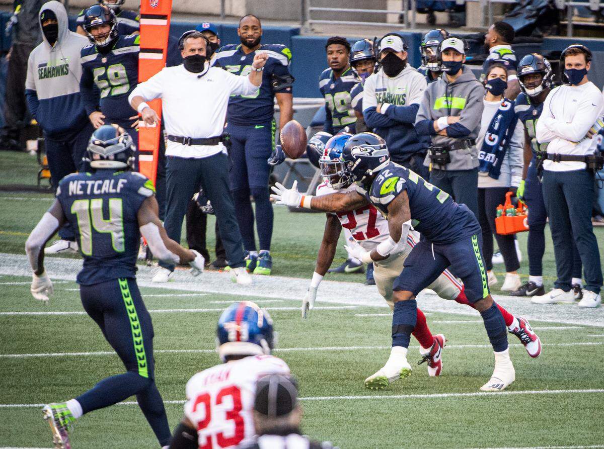 On 4th-and-1, a pass from Seattle Seahawks quarterback Russell Wilson to Seattle Seahawks running back Chris Carson is broken up by New York Giants defensive back Isaac Yiadom during the third quarter. The Seattle Seahawks played the New York Giants in a NFL football game at Lumen Field in Seattle, Wash., on Sunday, Dec. 6, 2020.
