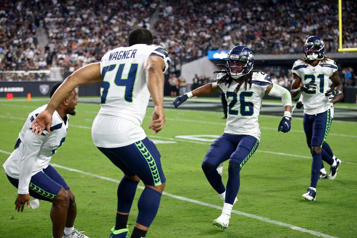 Seattle Seahawks defensive back Ryan Neal (26) celebrates after making an interception against the Las Vegas Raiders during the first half of an NFL preseason football game, Saturday, Aug. 14, 2021, in Las Vegas. (AP Photo/Steve Marcus)