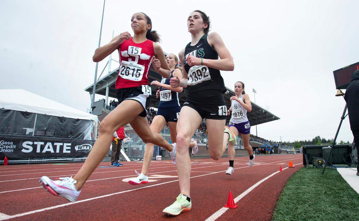 Shelton’s Alauna Carstens (left) passes East Valley’s Berlyn Stern en route to winning the state championship in the 2A girls 3200-meter run during the final day of the WIAA State Track and Field Championships at Mount Tahoma High School in Tacoma, Washington on Saturday, May 28, 2022.