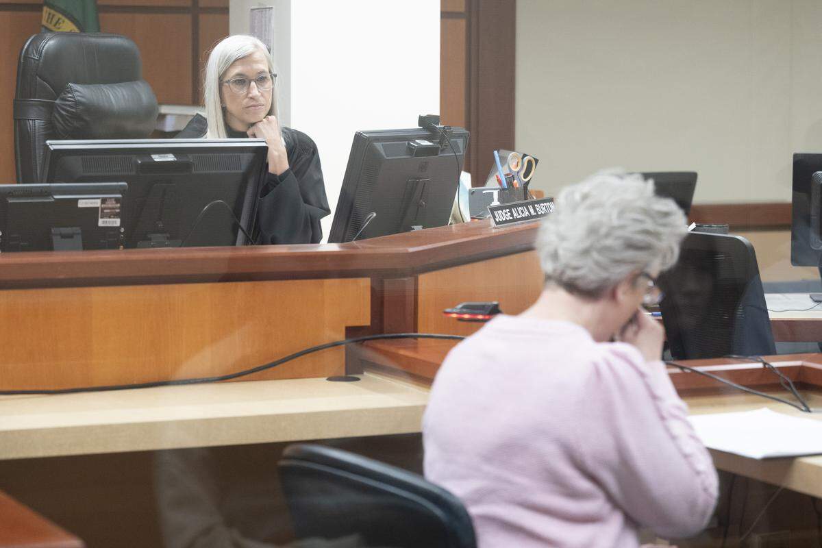 Judge Alicia Burton listens to victim Debra Hunton speak during a hearing and sentencing for former Pierce County Sheriff’s Office Maj. Chadwick Dickerson on Tuesday, April 14, 2026, at Pierce County Superior Court in Tacoma.