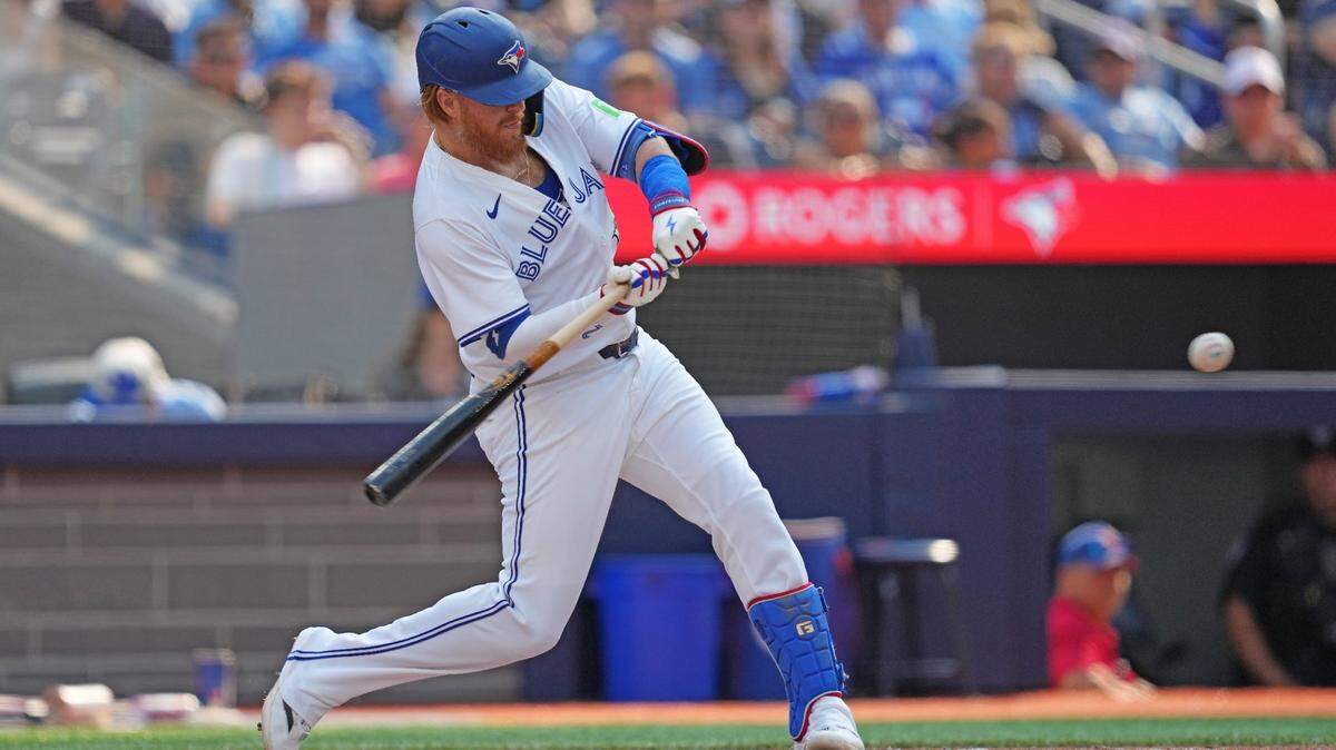Toronto Blue Jays designated hitter Justin Turner (2) hits a double against the Texas Rangers during the eighth inning at Rogers Centre on July 27.