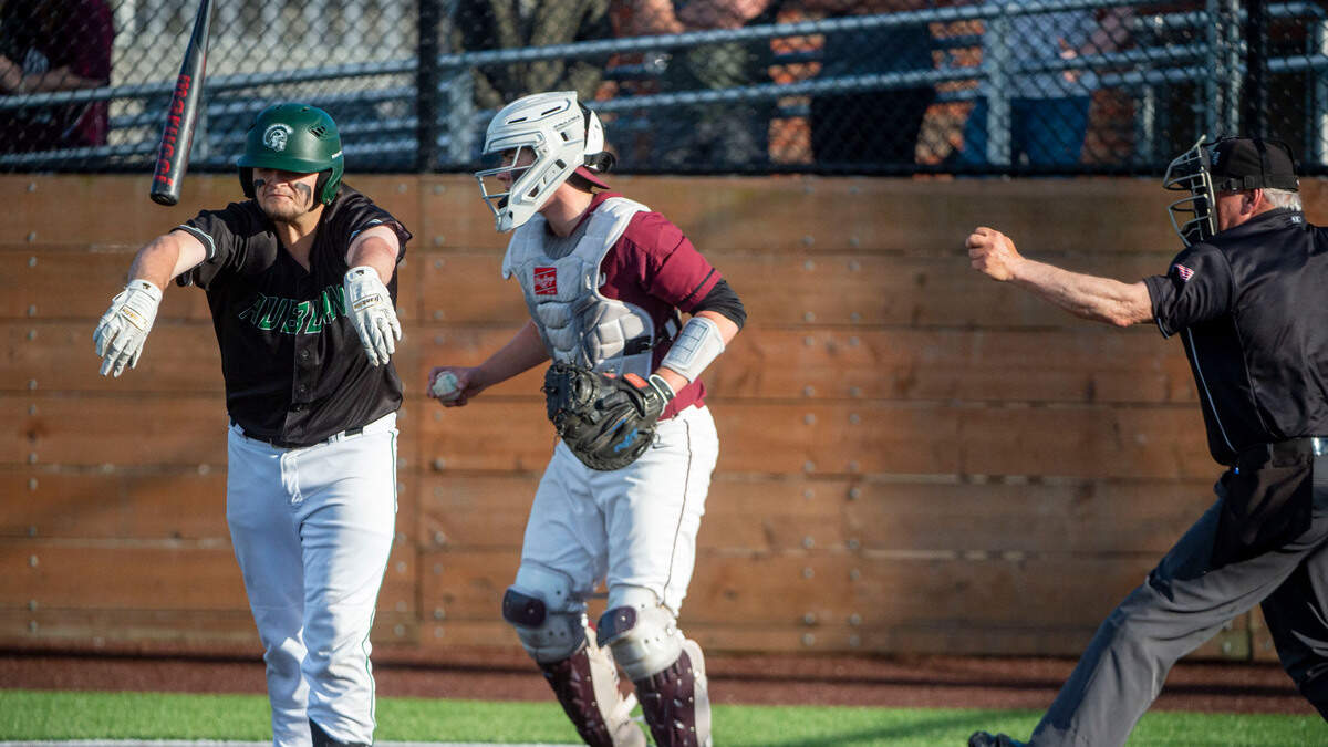 Auburn’s Connor Sloan throws his bat after being called out looking at a third strike in the top of the seventh inning of a State 3A playoff quarterfinal against Mercer Island on Saturday, May 21, 2022, at Auburn High School in Auburn, Wash. Sloan was thrown out of the game for his reaction.