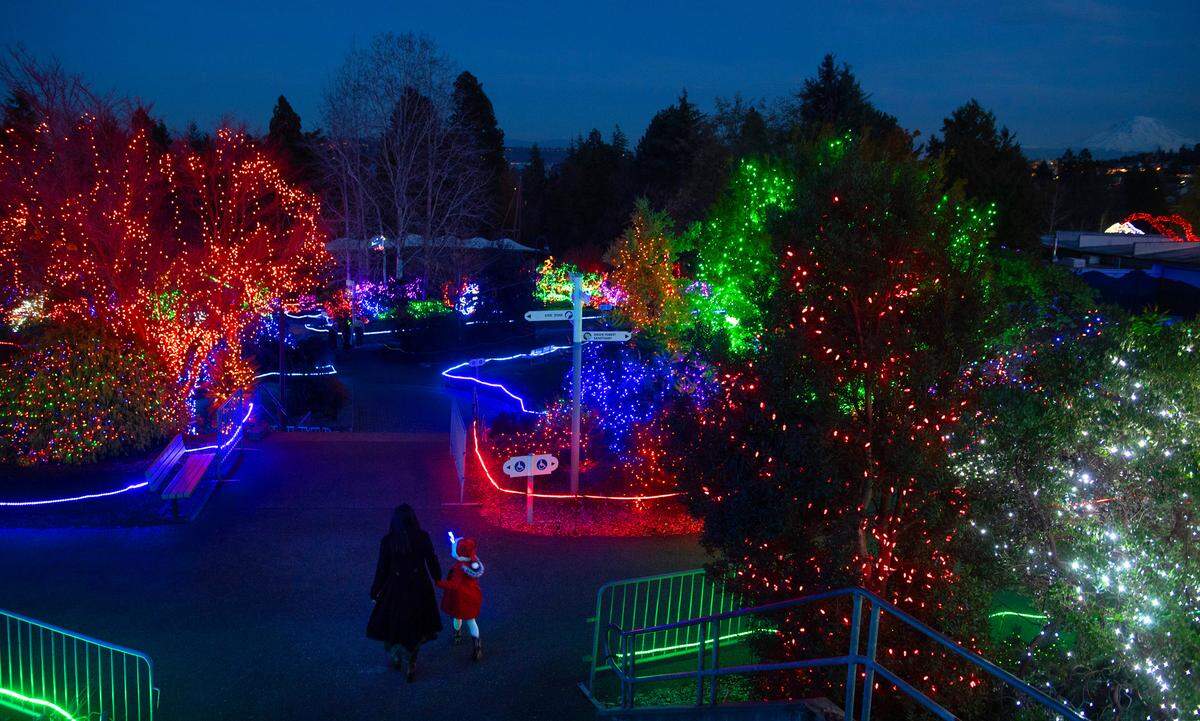 Preeti Weaver, of Buckley, and her daughter, Alaina, walk through the Zoolights at the Point Defiance Zoo & Aquarium in Tacoma, Washington, on Nov. 20, 2023.
