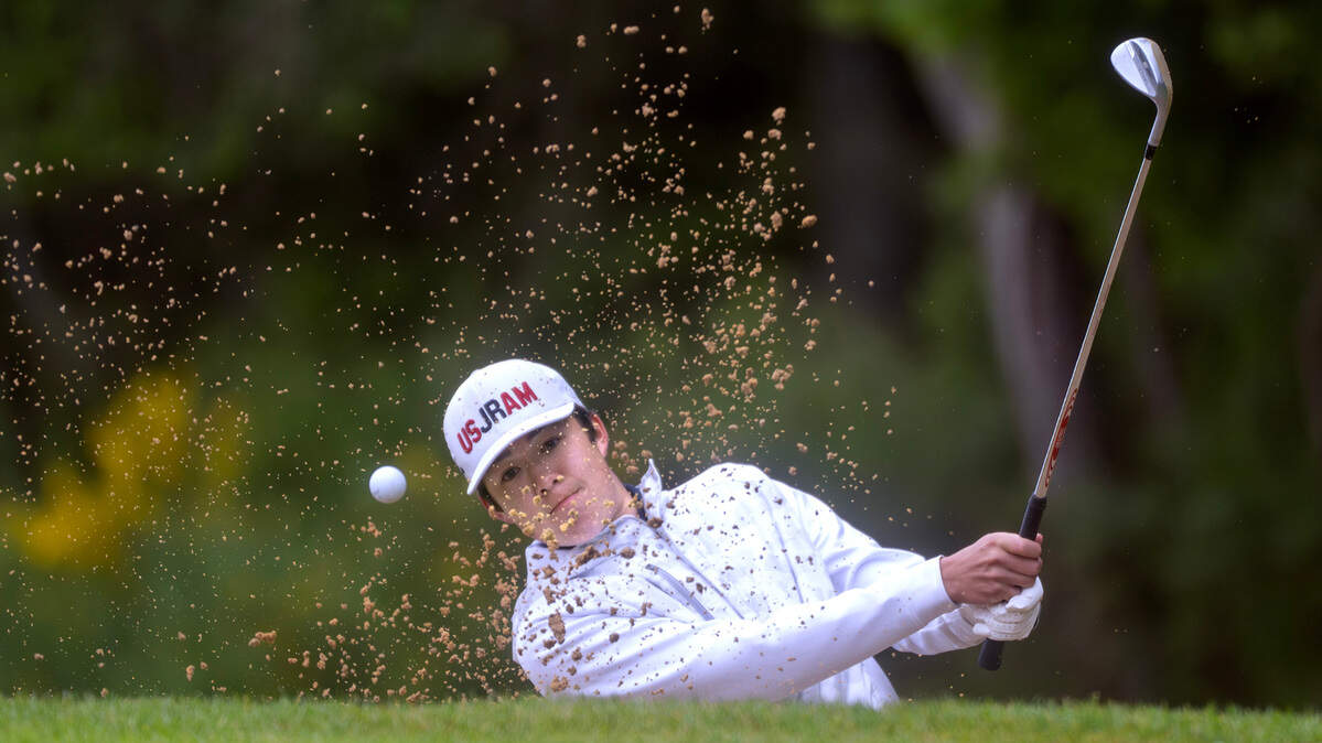 Gig Harbor’s Theo Snyder blasts out of the sand on the 16th hole during the opening day of the 3A Boys Golf State Championships at The Golf Club at Hawks Prairie in Lacey, Washington, on Tuesday, May 21, 2024.