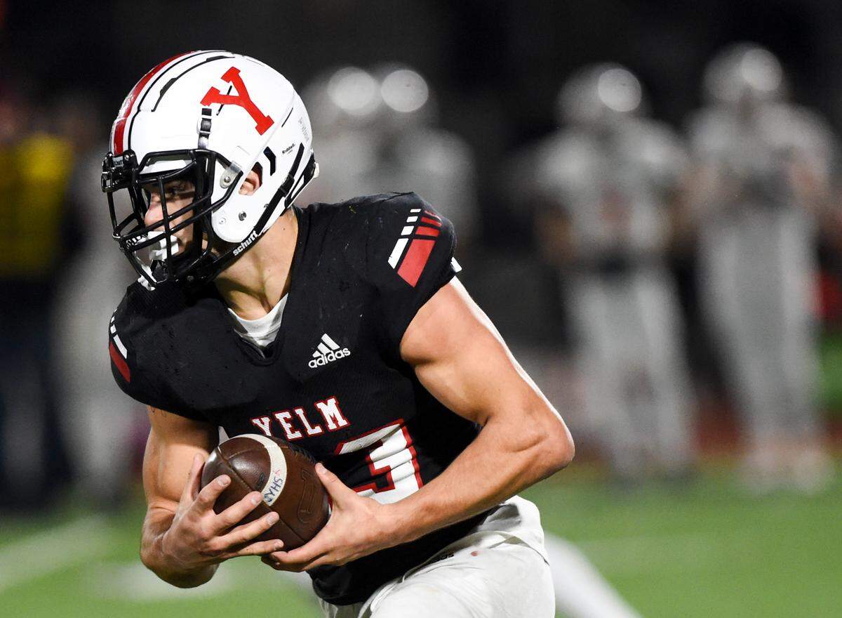 Yelm’s Brayden Platt (23) carries the ball during the first half of the 3A semifinal state game against Eastside Catholic at Art Crate Field, Saturday, Nov. 25, 2023, in Spanaway, Wash.