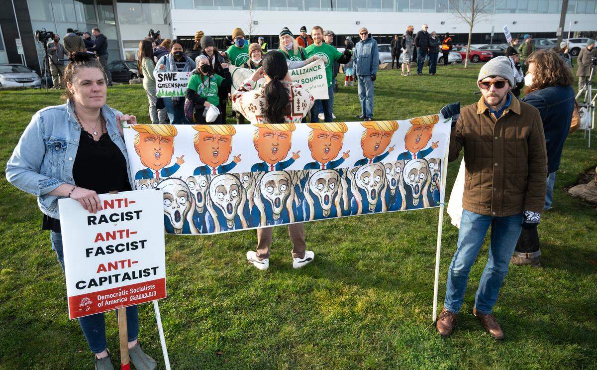Tracy Del Toro and Mark Copolongo, both of Tacoma, joined about 350 protesters gathered to oppose a variety of concerns, including the Trump agenda and the war in Gaza, during the “End the Attacks on the People!” protest rally at Fireman’s Park in downtown Tacoma, Washington, on Monday, Jan. 20, 2025.