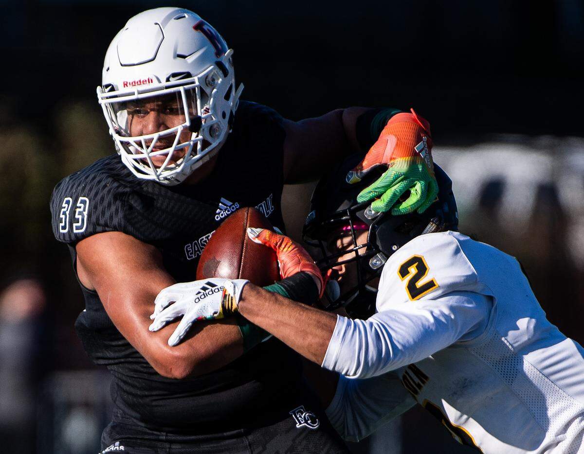 Eastside Catholic’s Jaylahn Tuimoloau runs as he’s tackled by Lincoln’s Jeddiah Hayes during the first quarter. Lincoln played Eastside Catholic in the 3A football semifinal game at Sammamish High School in Bellevue, Wash., on Saturday, Nov. 30, 2019.