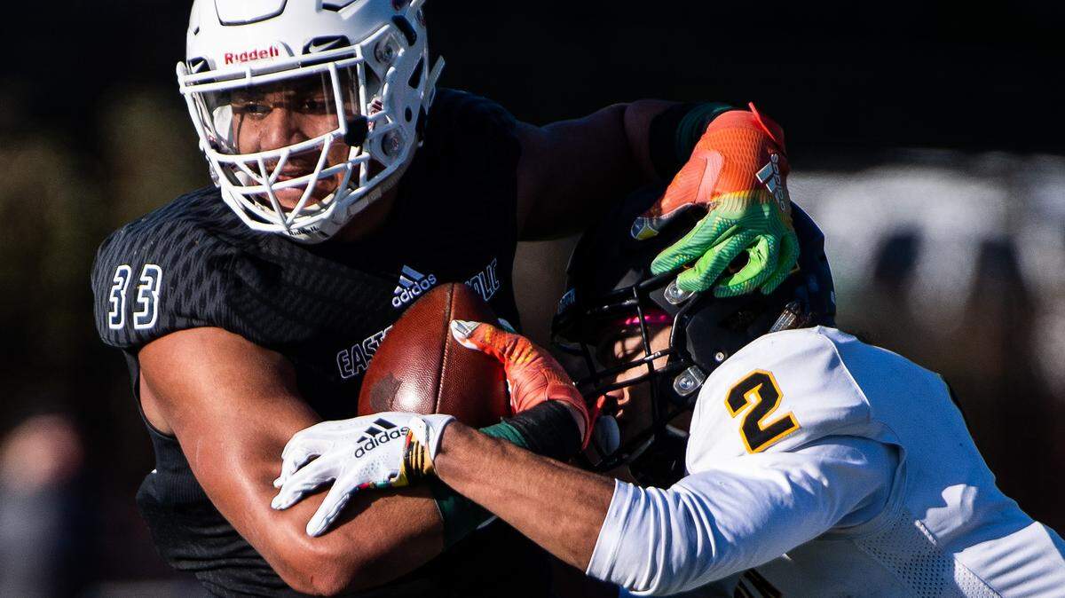 Eastside Catholic’s Jaylahn Tuimoloau runs as he’s tackled by Lincoln’s Jeddiah Hayes during the first quarter. Lincoln played Eastside Catholic in the 3A football semifinal game at Sammamish High School in Bellevue, Wash., on Saturday, Nov. 30, 2019.