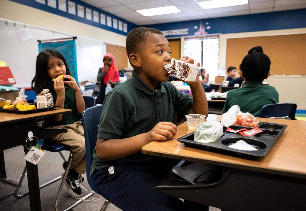 Evergreen Elementary first grade student James Thomas eats lunch at his desk in his classroom at the school in Spanaway on Friday, June 10, 2022.