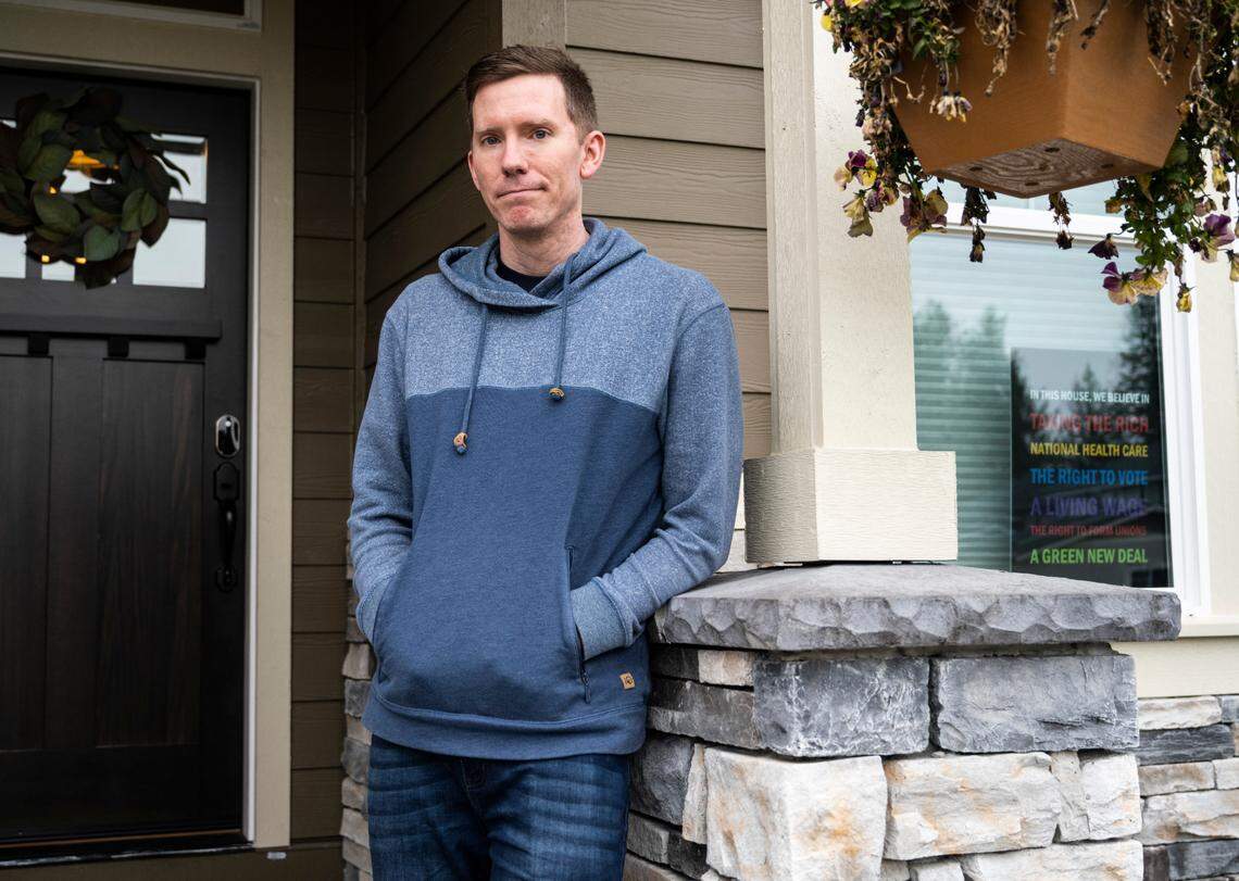 Michael Brandow poses outside his home in Bonney Lake on Thursday, March 10, 2022. Brandow is being sued by a builder for making a public records request for the blueprints to the house he bought last summer.
