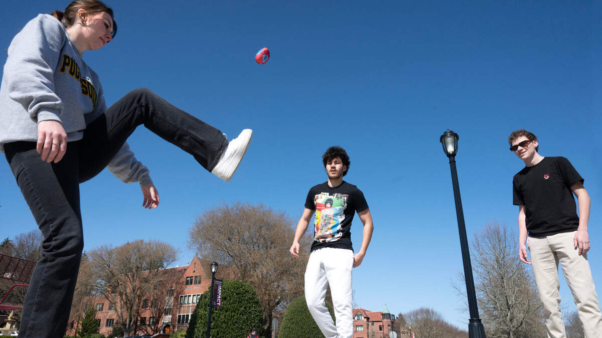 University of Puget Sound students (from left) Sarah DeBack, Brandon Nelson and Roan Huck play hackey sack in the sunshine on the campus in Tacoma, Washington, on Wednesday, March 22, 2023.