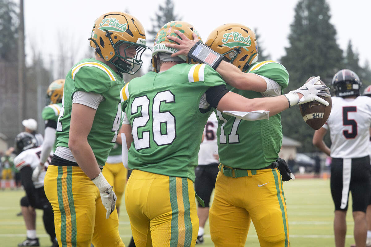 Teammates celebrate Tumwater running back Blake Heryford (26) after Heryford’s touchdown against Franklin Pierce on Saturday, Nov. 22, 2025, in Tumwater, Wash.