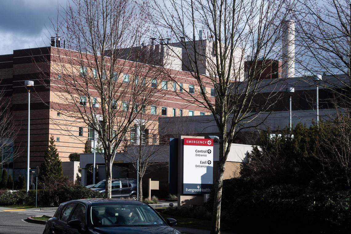 A car passes by EvergreenHealth Hospital in Kirkland, Wash., on Saturday, Feb. 29, 2020. Washington state health officials said Saturday that one person has died from the coronavirus in the state, the first reported death in the United States from the disease. Officials said the victim was a man in his late 50s. The person was a patient at EvergreenHealth Hospital.