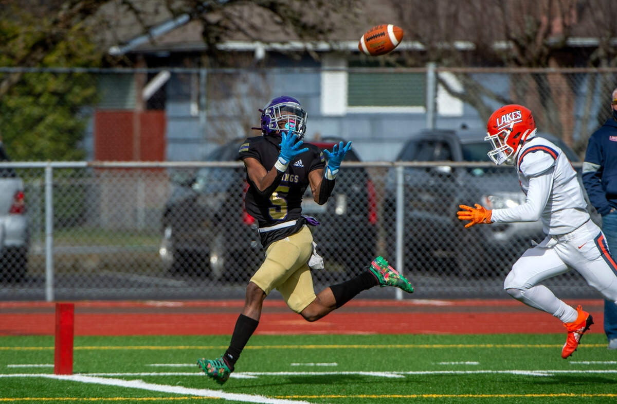 Puyallup wide receiver Jaylan King outruns Lancers defensive back Aidan Wisdom to haul in a long pass from quarterback Luke Holcomb for a third quarter TD. The Vikings rolled to a 44-16 victory over the Lancers at Sparks Stadium in Puyallup Saturday, Feb. 27, 2021.