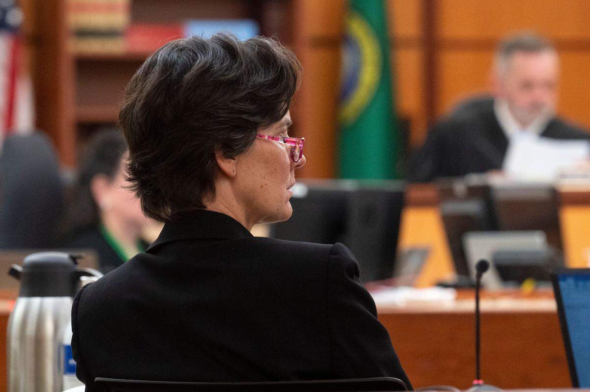 Washington state assistant attorney general Melanie Tratnik listens as Anne Bremner, the defense attorney for Pierce County Ed Troyer, addresses the court on Monday, Dec. 12, 2022, in Pierce County District Court in Tacoma.